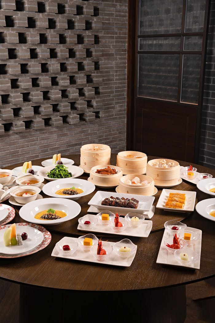 An array of exquisite dim sum dishes elegantly presented in a stylish indoor setting.